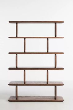 a wooden shelf with glass shelves on each side and one shelf below it, against a white background