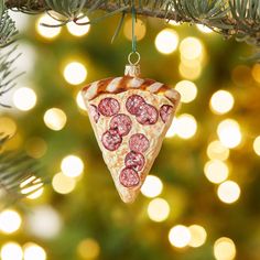 a pepperoni pizza ornament hanging from a christmas tree