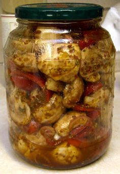 a jar filled with lots of food sitting on top of a counter