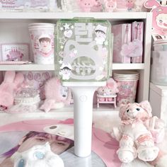 there is a pink and white room with many items on the shelves, including teddy bears