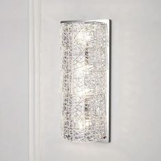 a wall light that is mounted on the side of a white wall in a room