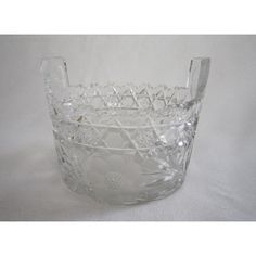 a clear glass bowl sitting on top of a white table