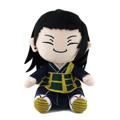 a stuffed toy doll with black hair and green outfit sitting on a white surface,