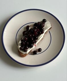 a piece of cake with cherries on it sitting on a white and blue plate