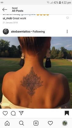 the back of a woman's neck with tattoos on it