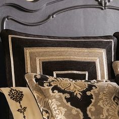 a black and gold bed with decorative pillows