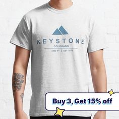 a man wearing a white t - shirt with the words key stone on it