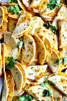 several tortilla shells with cheese and cilantro