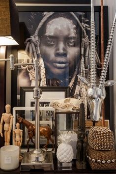 a shelf with various items on top of it and a framed photo above the shelves