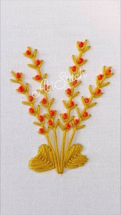 the embroidery design is done in gold and red thread with small flowers on each side