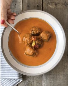 a bowl of soup with meatballs in it