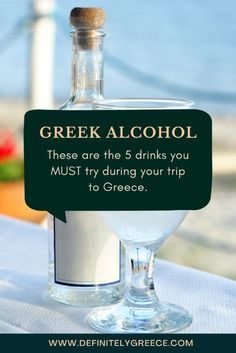 a bottle of alcohol sitting on top of a table next to a sign that says, greek alcohol