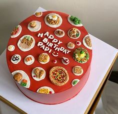 a red birthday cake with lots of food on it