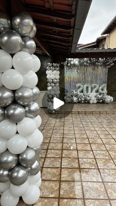 balloons and streamers are on the ground in front of an entrance to a building