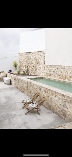 an outdoor hot tub with chairs around it on the concrete floor and outside patio area