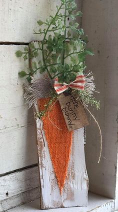 a wooden block with a carrot hanging from it's side