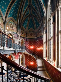 the front cover of an architectural magazine, with stairs and chandeliers on either side