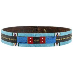 Nez Perce beaded belt on harness leather adorned with brass diamonds in the center. Trunk piece - stored and in great condition. Beautiful colors of blues, reds, whites, orange and green. No disappointments here!! Ex. Likkel. Period: First quarter of the 19th century Origin: Nez Perce Size: 39" L x 2 1/4" W.      Family Owned & Operated Cisco’s Gallery deals in the rare, exceptional, and one-of-a-kind pieces that define the history of America and the Old West. Our pieces range from American Indi Beaded Belts, Native American Clothing, Native Beadwork, Nativity Crafts, Beaded Belt, Native American Beading, American Clothing, Orange And Green, Arte Popular