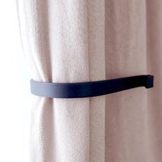 a curtain with a black belt hanging from it's side