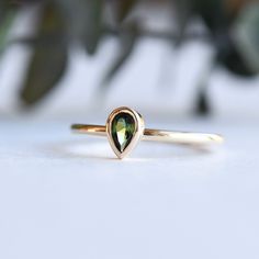 DESCRIPTION: >Tourmaline-adorned teardrop ring. >14k yellow gold fully hallmarked. >Approx 1.4mm band width >3mm x 5mm tourmaline stone. FREE SHIPPING USA- All of our jewelry will arrive in custom packaging ready for gift giving. LEAD TIME: Made to order will take 10-14 days. Signature upon delivery, we unfortunately will not be able to reimburse or replace lost or stolen shipments. FOLLOW US ON: Instagram: @roseandchoc Facebook: /Roseandchoc Pinterest: @Roseandchoc 14k Gold Teardrop Ring, Teardrop Yellow Gold Sapphire Ring, Yellow Gold Teardrop Sapphire Ring Fine Jewelry, Teardrop Sapphire Ring In Yellow Gold, Yellow Gold Teardrop May Birthstone Ring, Yellow Gold Teardrop Ring For May Birthstone, Gold Pear Ring, Engagement Ring Teardrop, Ring Teardrop