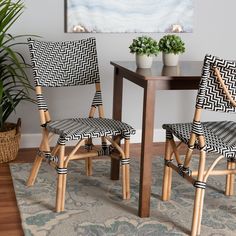 two chairs with black and white patterned upholstered back rest at a small table