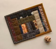 a close up of a piece of fabric on a table with a small object next to it