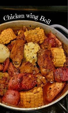 a pan filled with chicken and corn on the cob