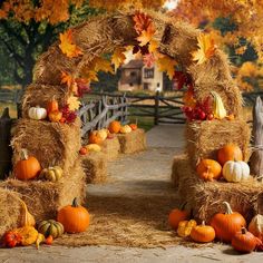 hay bales with pumpkins and gourds are arranged in the shape of an arch