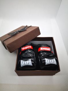 two pairs of black and red shoes in a box