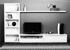 a white entertainment center with bookshelves and a flat screen tv