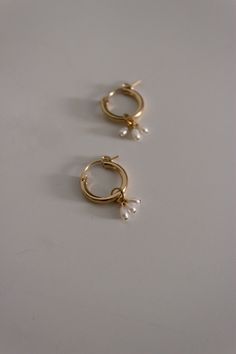 "Modern, minimal and fresh! These earrings feature a mini hoop that hugs the earlobe and a genuine tiny 2-3mm freshwater pearl cluster dangle. They are perfect for everyday wear! Lightweight and comfortable to wear. Wear them two ways - slide the dangle off to wear just the simple hoop earring. D E T A I L S Materials: 14K Gold Fill or Sterling Silver Closure: latch hook S I Z E S Measures appox. 1 1/4\" in length M A T E R I A L S With so many terms to describe gold jewelry, it can be confusing Affordable Fine Jewelry, Elizabeth Jewelry, Simple Hoop Earrings, Ear Ring, Mini Hoop Earrings, Latch Hook, Pearl Cluster, Earrings Inspiration, Wardrobe Inspiration