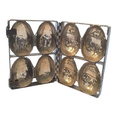 an old metal egg holder with six golden eggs in it's sides and four smaller ones on the other side