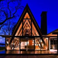 a large wooden house lit up at night