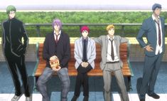 four men in suits sitting on a bench