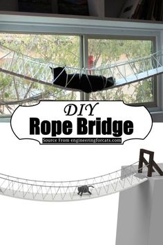 the rope bridge is in front of a window with a cat sitting on top of it