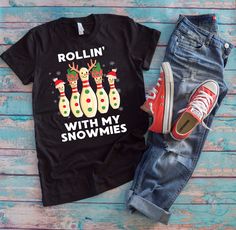 a t - shirt that says rollin'with my snowmies on it next to sneakers