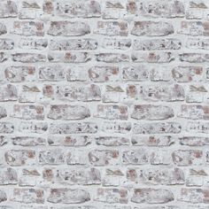 an old brick wall is shown in grey and white colors, with small bricks on the side