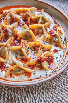 a bowl filled with pasta and sauce on top of a table