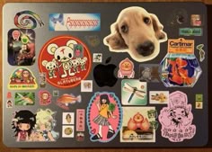 a dog's face is covered in stickers on the back of an apple laptop