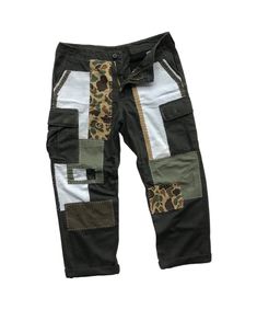 "Description: Uniqueness is here for those who love‼️ It's originally military pants in olive green herringbone pattern. Then, it's artistically full hand reworked and patched using several fabric materials and patterns, in order to make it unique and precious. However, its cargo style still remains as original since it contains multiple pockets like other military pants. Photos and videos describes the product better. So, just have a look-see at them all and read the special features below before you decide to purchase it.  Features: - Patchwork military pants. - Reworked cargo pants with multiple pockets. - Different fabric patterns and materials were patched as detailing.  - Full hand sewing stitches. - Herringbone pattern fabric. - Relaxed fit. Size: Waist: 33 - 37\" (Adjustable)  Hips Olive Military Style Pants For Streetwear, Olive Military Cargo Pants With Patch Pockets, Military Style Olive Cargo Pants For Streetwear, Olive Military Cargo Pants For Streetwear, Khaki Cotton Patchwork Bottoms, Utility Style Patchwork Bottoms For Streetwear, Utility Patchwork Bottoms For Streetwear, Utility Style Cotton Pants With Patchwork, Cotton Utility Pants With Patchwork