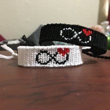 two wristbands that have been made to look like skulls and hearts on them