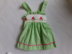 Fun and adorable hand smock watermelon dress. The front is as cute as the big bow in the back. Hand smocked watermelon with pink ric-rac  on the bottom of the dress. The dress is machine washable Watermelon Dress, Fun Towels, Hand Smocked Dress, Toddler Beach, Baby Girls Dresses, Hand Smock, Summer Watermelon, Ric Rac, Smocked Dress