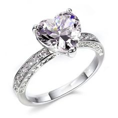 a white gold ring with an oval cut diamond and pave set diamonds on the sides