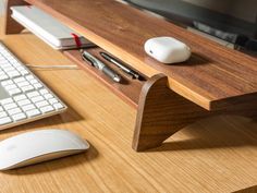 a computer desk with a keyboard, mouse and monitor sitting on it's side