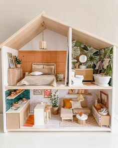 a doll house with furniture and accessories inside