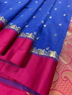 Gorgeous Statement designer Saree by Kaash Collection. Blue with small Buttis all over the body of the Saree. Plain Magenta Pink Color Borders and Zari Weaved Pallu in ambi Style. Item : SareeColor : Blue with Magenta Pink Border Base Fabric : Soft Banarasi Silk Blouse piece : Comes with Blouse pieceBlouse material : Soft Banarasi Silk Work : Handloom Fall & Edging(Yes/No) : Yes Disclaimer -:- Color variation is possible due to various reasons like phone or desktop setting, resolution etc. Pleas Blue Anarkali Art Silk Saree, Blue Saree With Traditional Patterns For Festivals, Traditional Blue Chanderi Lehenga, Traditional Blue Art Silk Lehenga, Blue Saree For Traditional Ceremonies, Royal Blue Silk Traditional Wear For Festivals, Blue Tussar Silk Anarkali Saree, Blue Art Silk Lehenga For Puja, Festive Blue Lehenga With Traditional Patterns