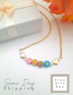 Childs Name Necklace Toddler Girl Necklace Hearts Kids Personalized Necklace Little Girl Jewelry Name Necklace for Christmas Birthday Gift   Simply adorable, colorful and oh, so sweet! This cute and fun necklace can be personalized with any name, word or phrase that you would like for your personalized necklace. Letters are randomly chosen from the color palette shown in the photos for a unique personalized style. The beads are made from a plastic resin material with an inlay of a gold printed letter. The Chain is a 12K gold plated hand cut chain. We hand cut each chain for all our guests. We ensure that each necklace is carefully crafted with all the personal details for your special order.  M A T E R I A L S ~ Colorful Beads, 12K Gold Plated Hand cut Chain  N E C K L A C E ~ L E N G T H Toddler Necklace, Jewelry Name, Girl Necklace, Artisan Gift, Girl Jewelry, Letter Beads, Plastic Resin, Heart For Kids, Gold Print