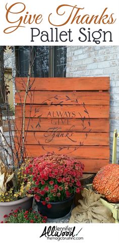 a wooden pallet sign sitting on top of a pile of flowers