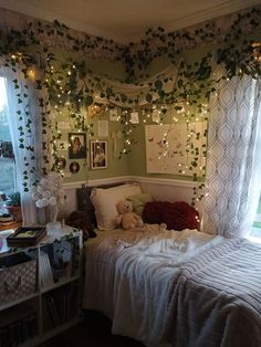 a bedroom decorated with ivy and fairy lights