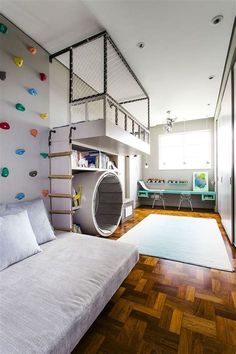 a living room filled with furniture and a spiral staircase in the middle of it's wall